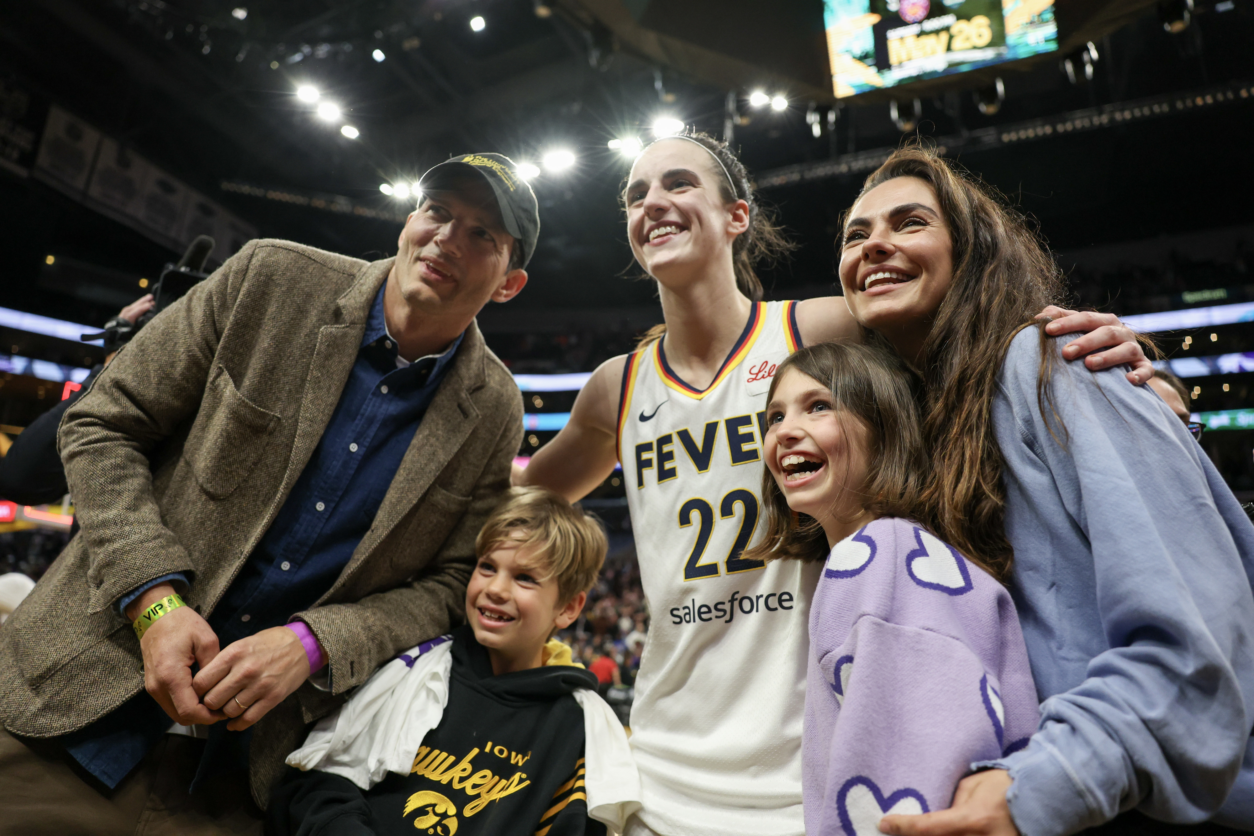 Ashton Kutcher, Mila Kunis, their kids, Wyatt and Dimitri, with Caitlin Clark