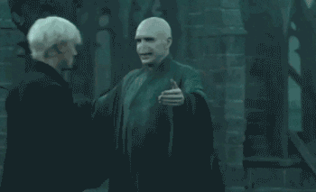 Draco Malfoy and Voldemort awkwardly hug in a scene from Harry Potter