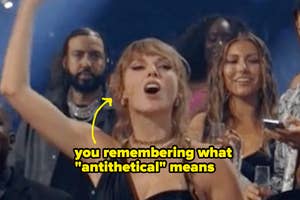 Taylor Swift raising her arm on stage with the caption "you remembering what 'antithetical' means" over the image. Others look on in the background