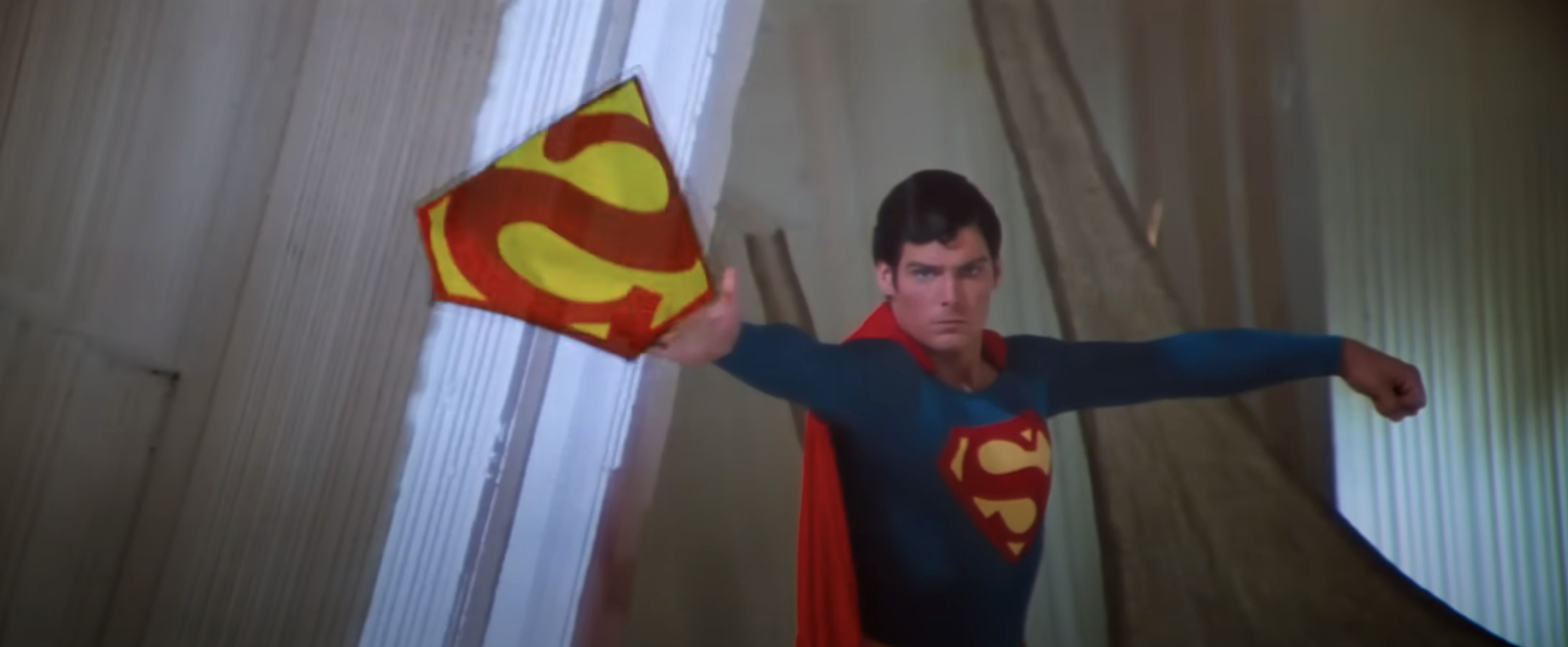 Christopher Reeve as Superman throws his emblem in a scene from a Superman film