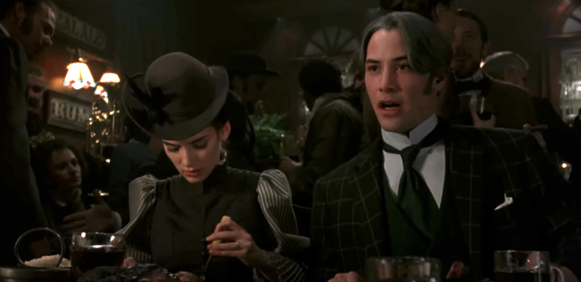 Winona Ryder and Keanu Reeves in period clothing at a formal dinner scene from the movie &quot;Bram Stoker&#x27;s Dracula.&quot;