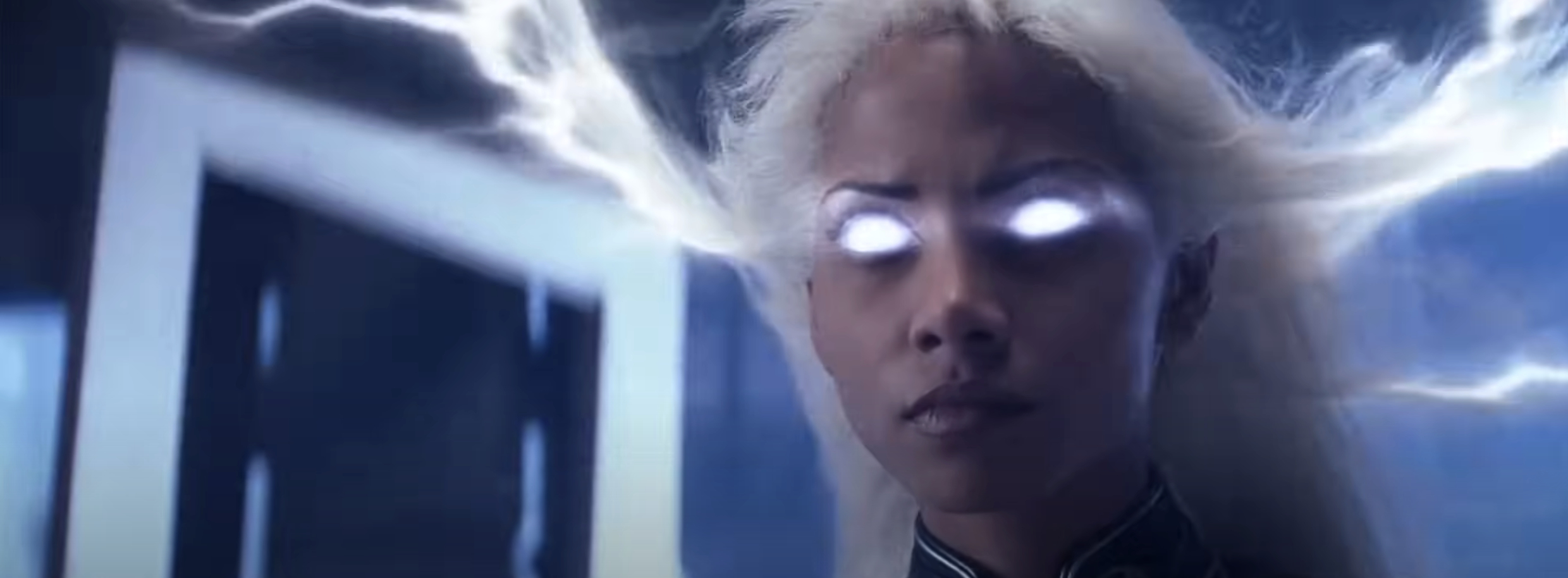 Image of Storm from X-Men with glowing white eyes and lightning emanating from her head. She appears powerful and focused