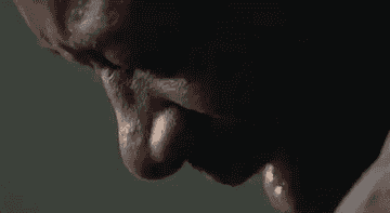 A pensive close-up of a person with eyes closed and a distressed expression. The focus is on the face, emphasizing emotion. The person's identity is not clear