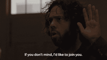 Man in a dark room raising his hand says, &quot;If you don't mind, I'd like to join you.&quot;