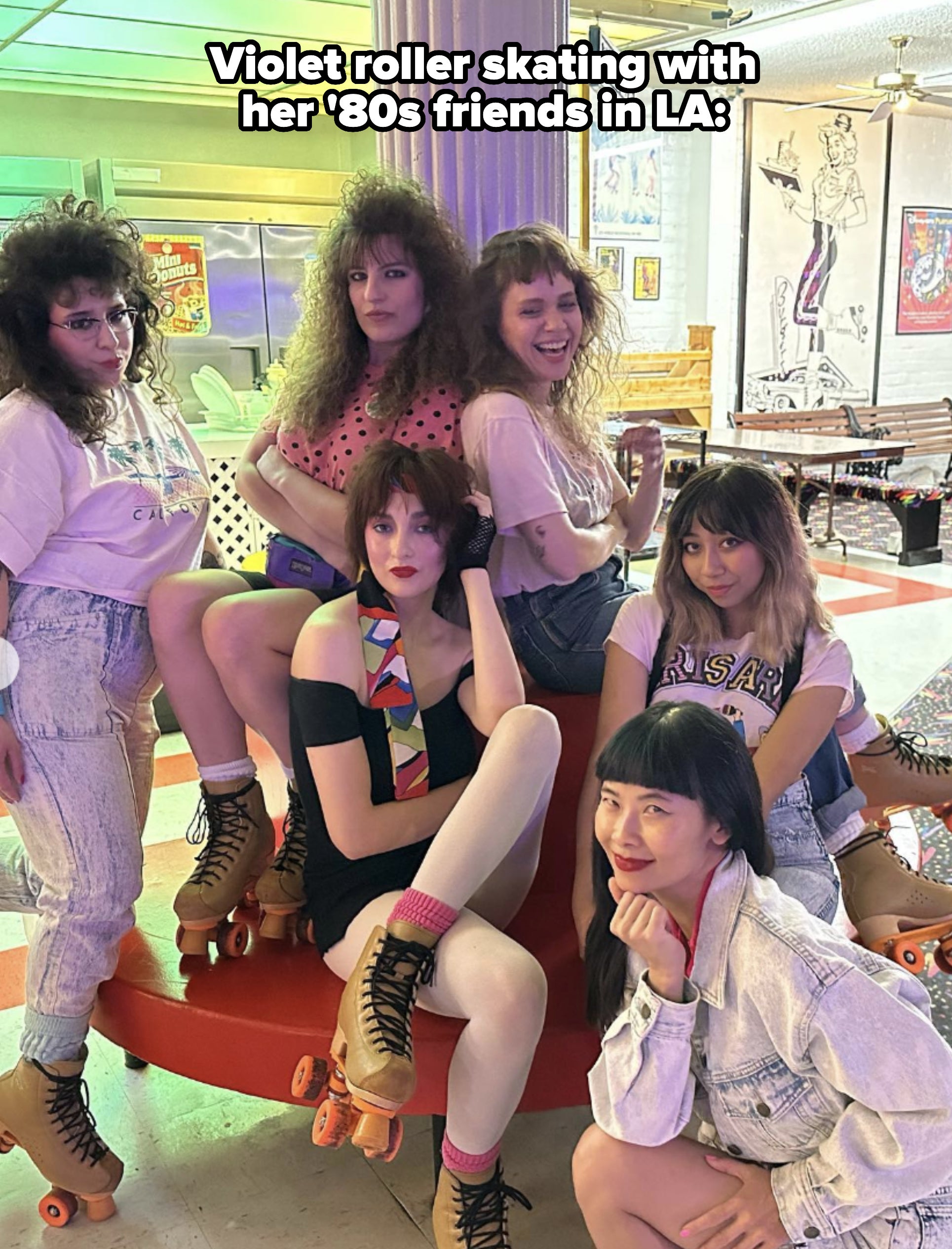 Six women posing in roller skates in a retro-themed setting. They have different poses and expressions, each showcasing unique fashion styles