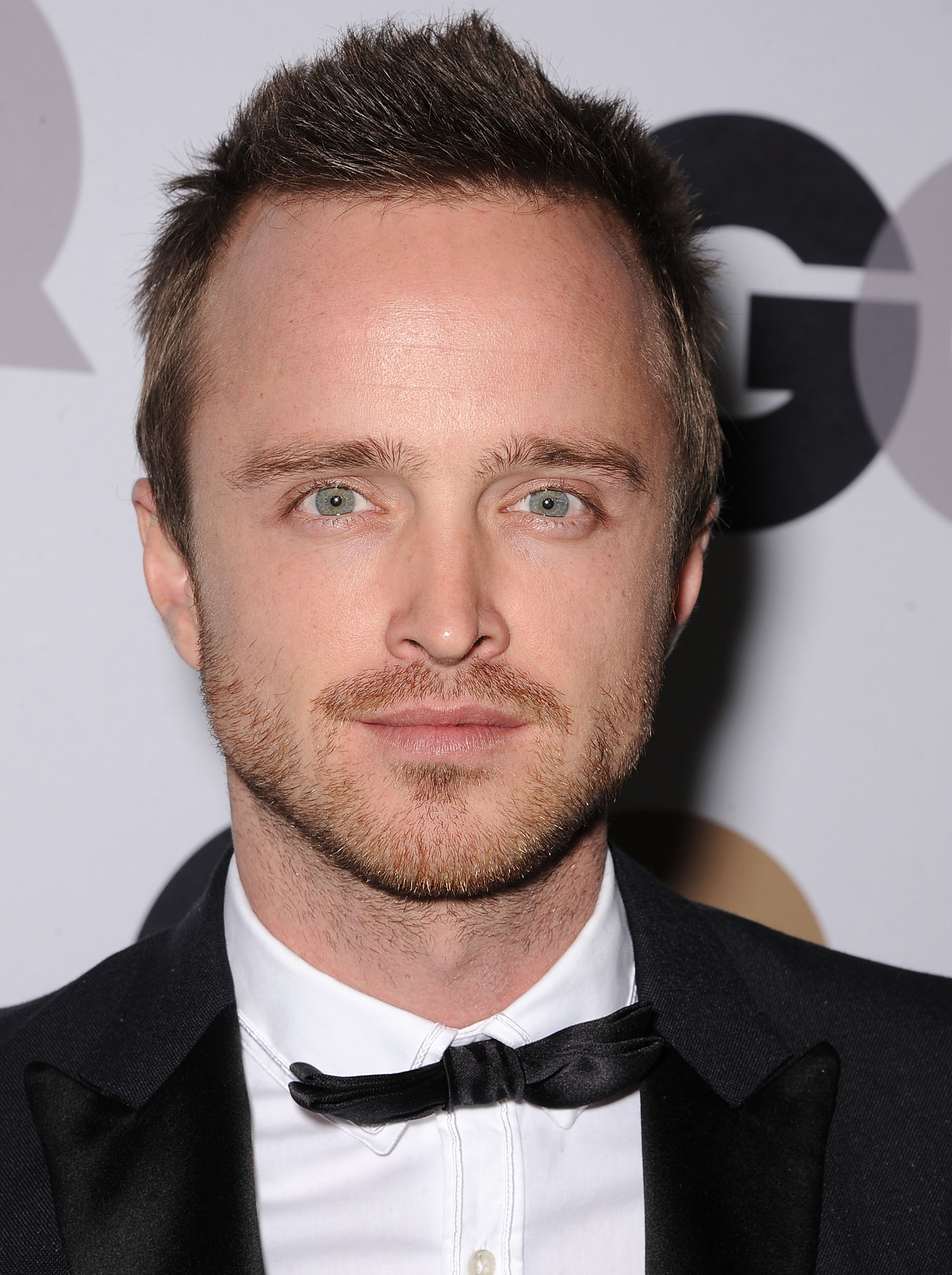 Aaron Paul at a GQ event, in a tuxedo with a bow tie