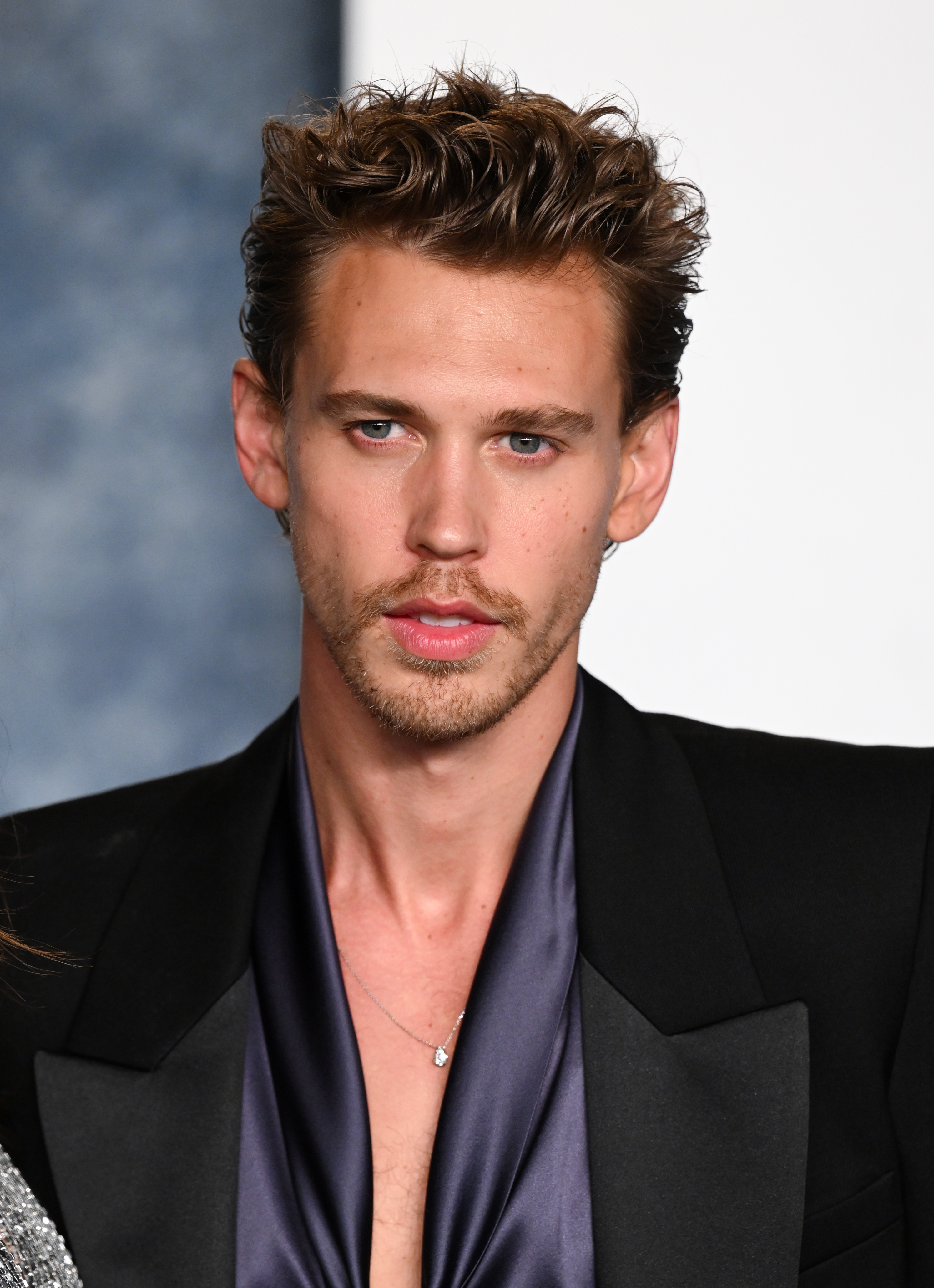 Austin Butler in a black blazer and satin shirt