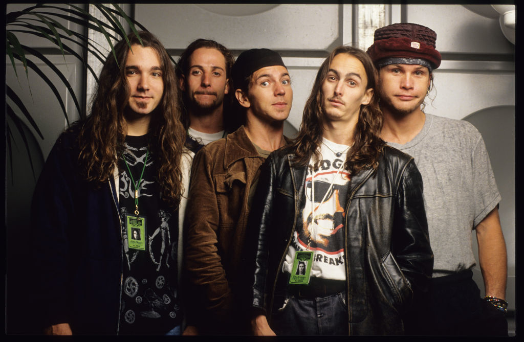 Eddie Vedder, Stone Gossard, Jeff Ament, Mike McCready, and Dave Krusen, members of the band Pearl Jam, posing together in casual, rock-style clothing