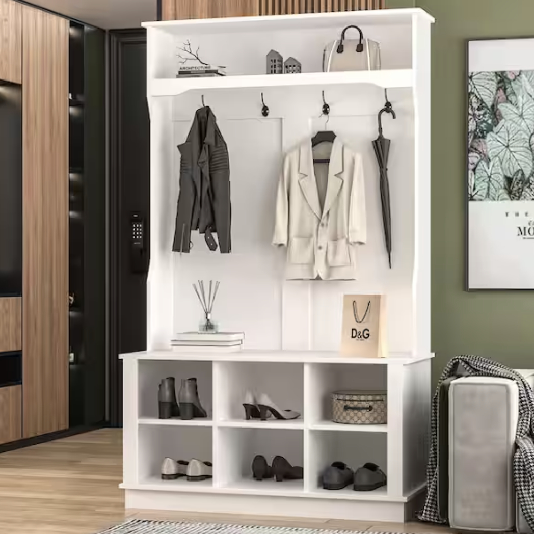 White hall tree with hooks holding a gray jacket, white blazer, and umbrella. Open cubbies below display shoes, a handbag, and a D&amp;amp;G shopping bag