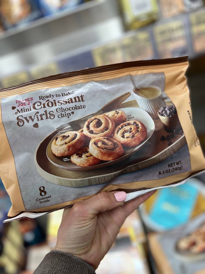 Hand holding a package of Trader Joe's Ready to Bake Mini Croissant Swirls with chocolate chips.