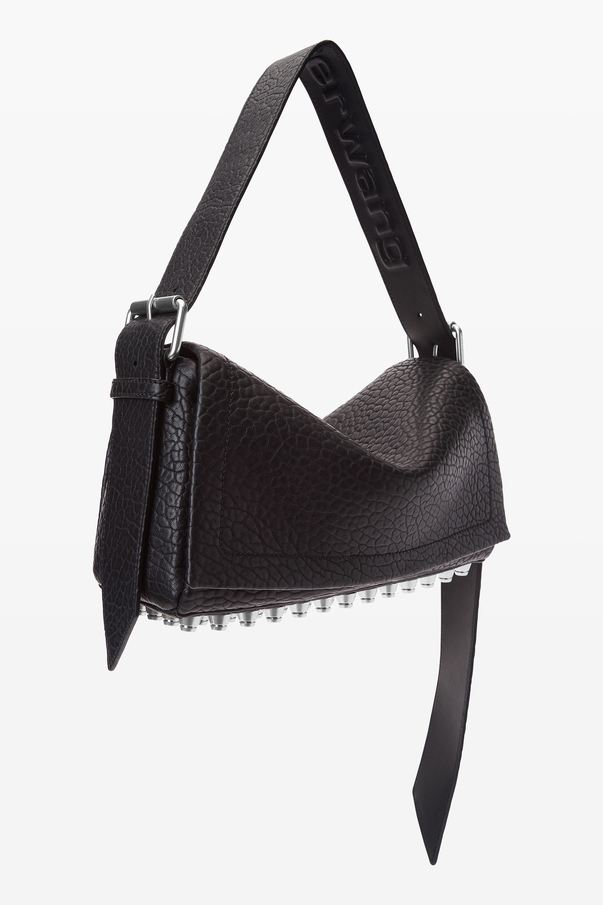 A textured leather handbag with a wide strap and metal stud detailing on the bottom, designed by Alexander Wang