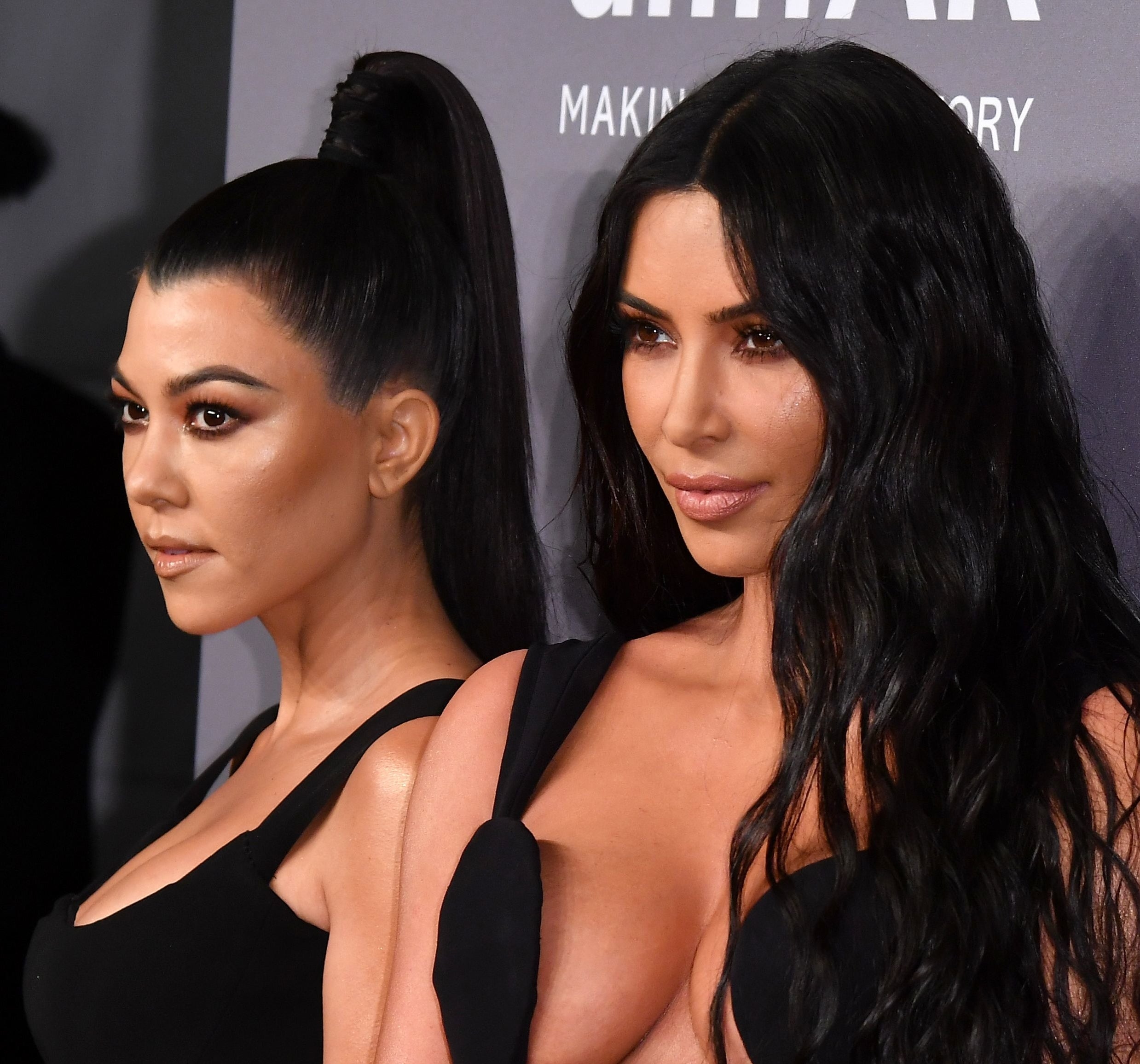 Kim Kardashian and Kourtney Kardashian at a red carpet event