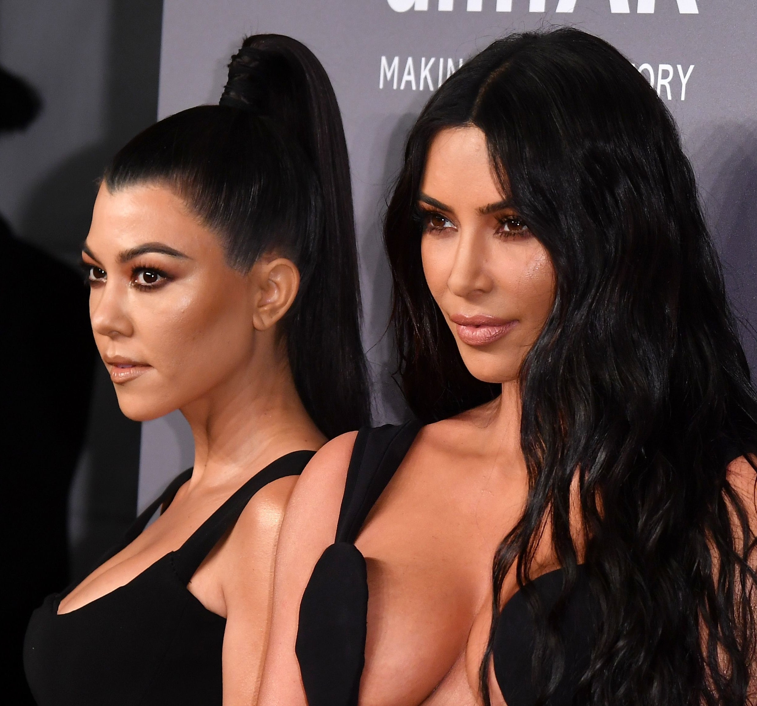 Kim Kardashian and Kourtney Kardashian at a red carpet event