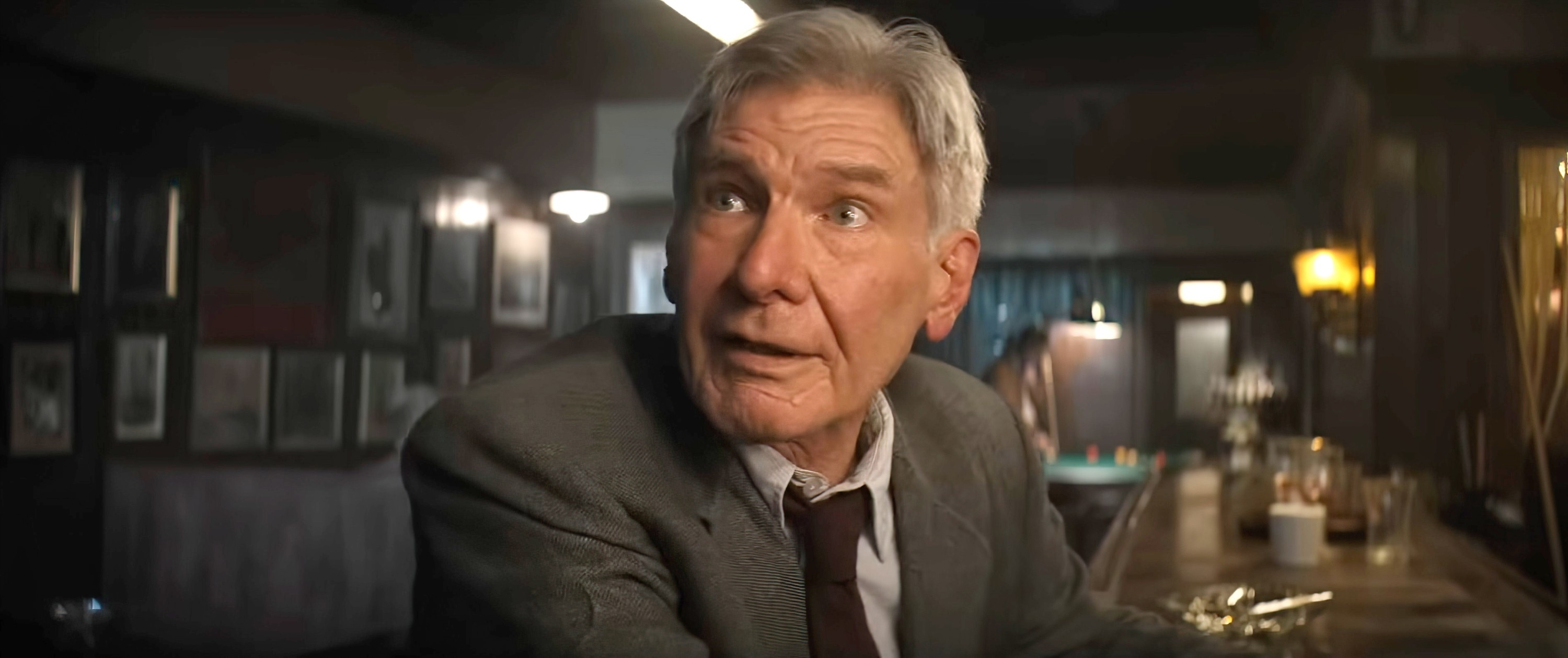Harrison Ford appears startled while sitting at a bar in a scene