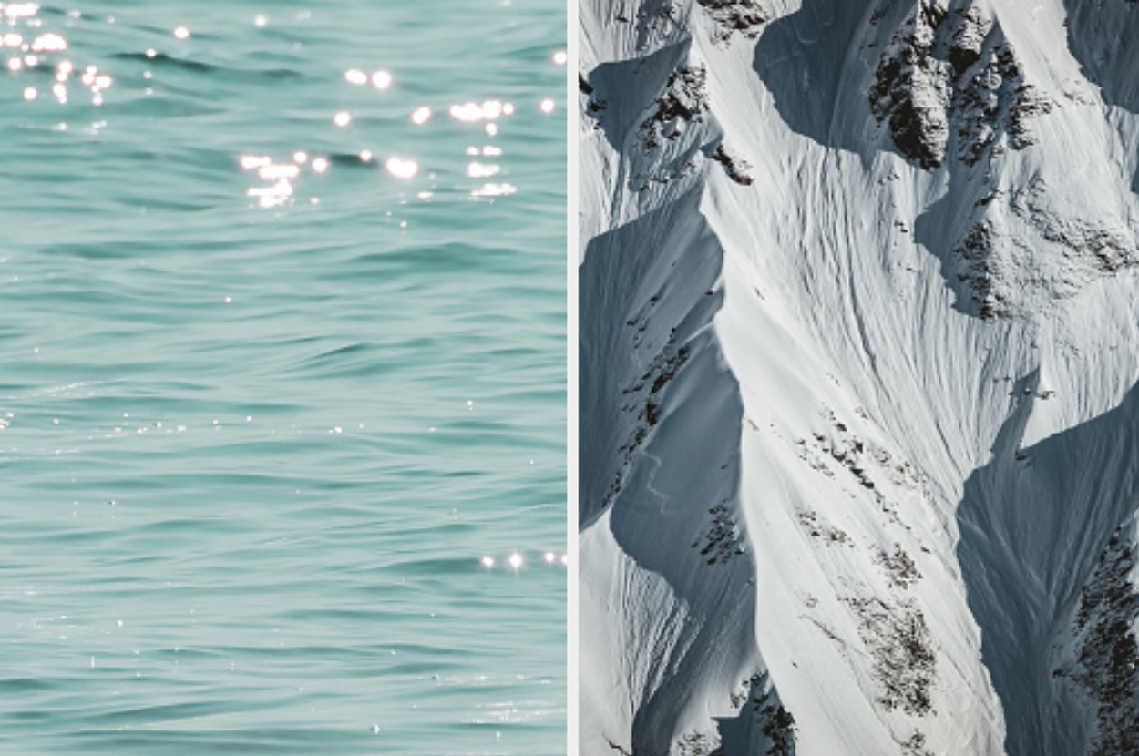 在左边，阳光在波涛汹涌的水面上闪闪发光。右侧是积雪覆盖的山坡，有可见的山脊和阴影