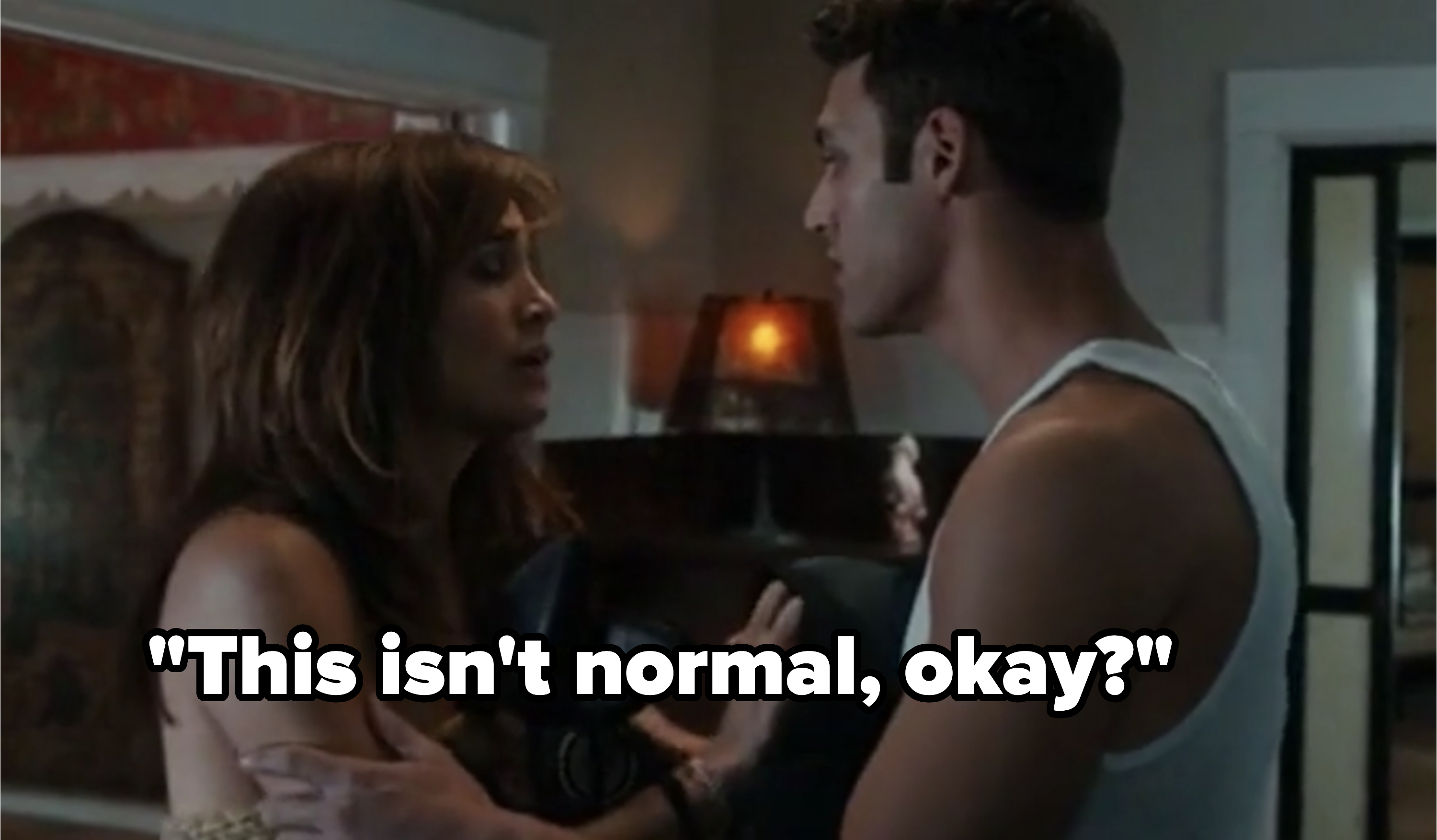 Jennifer Lopez and Ryan Guzman in an intense scene from the movie &quot;The Boy Next Door,&quot; standing close to each other in a dimly lit room