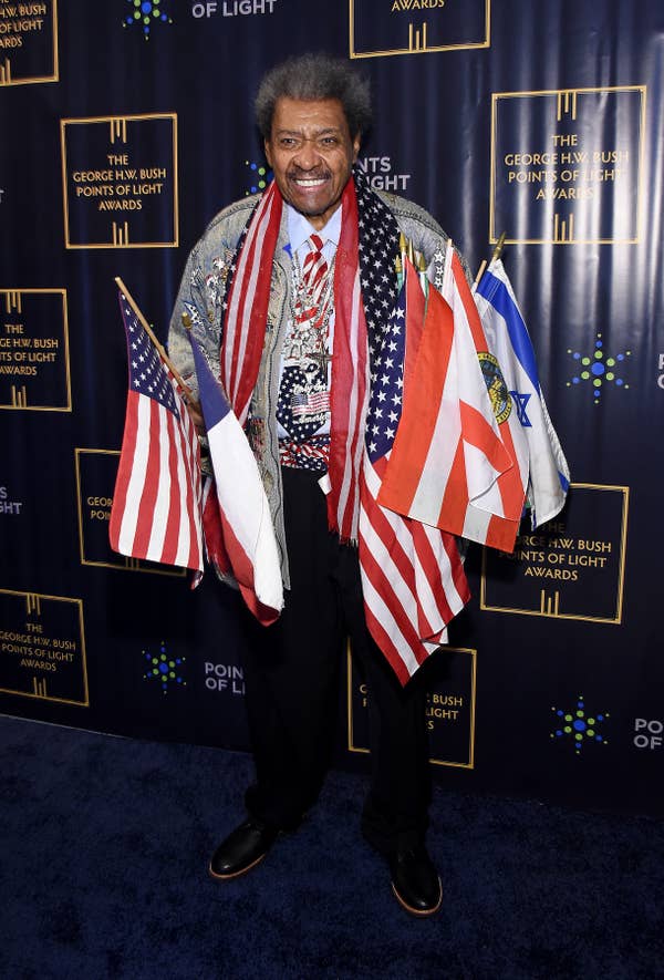 Don King at the George H.W. Bush Points of Light Awards, wearing flags of various countries draped over his outfit