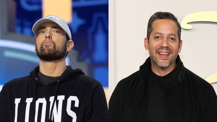 Eminem in a black hoodie with &quot;LIONS&quot; written on it stands next to David Blaine, who is smiling and wearing a black jacket