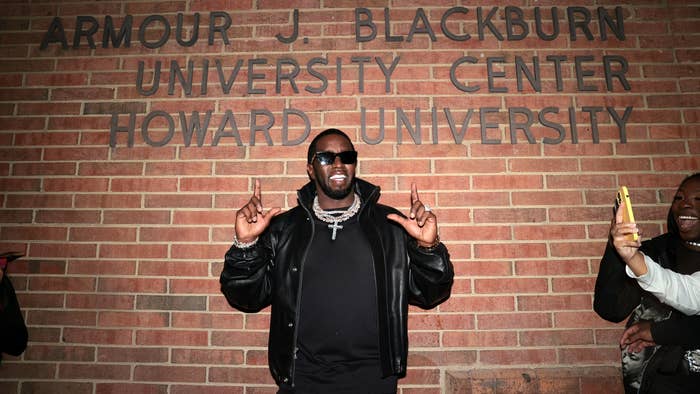 Sean &quot;Diddy&quot; Combs stands in front of the Armour J. Blackburn University Center at Howard University, smiling and pointing upwards