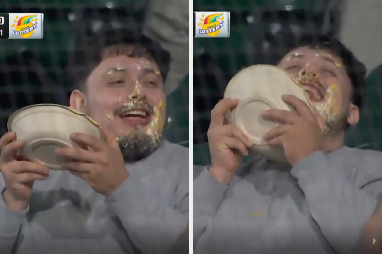 A man is seen joyfully eating and smearing his face with food while holding a bowl