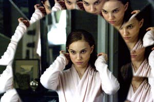 Natalie Portman fixes her hair while looking into a fractured mirror, revealing multiple reflections of her face