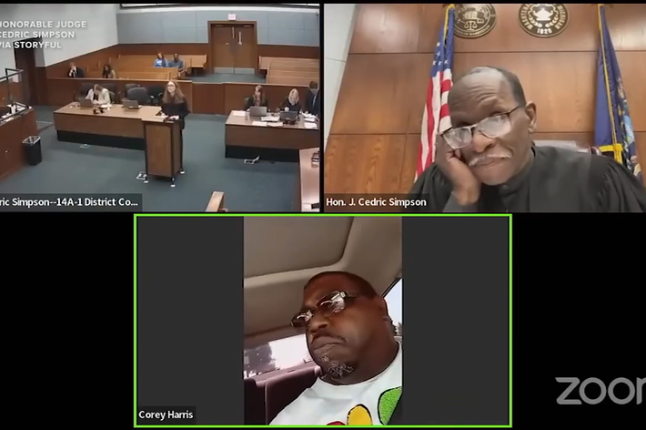 Hon. L. Cedric Simpson presides over a virtual courtroom. Corey Harris appears remotely. Court officials are visible in the physical courtroom. "Zoom" logo on the screen