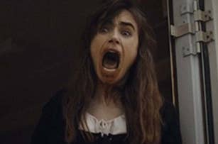 A person with long hair and an open mouth, appearing to be screaming, stands in a doorway