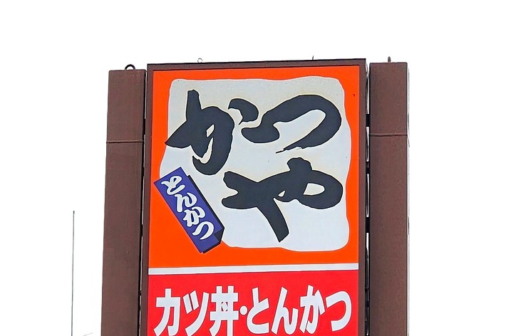 画像には、「ぎゅうにゅう」の大きな文字と「おいしい」という小さな文字が含まれている宣伝看板です。
