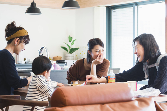 Two side-by-side images of the same woman looking thoughtful. In the right image, she is touching her hair. She wears a long-sleeve zip-up top