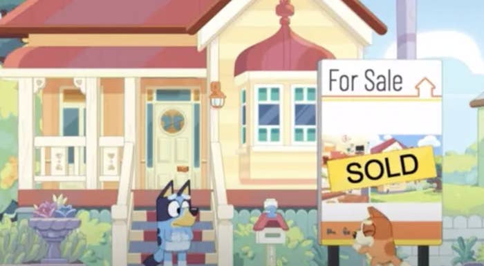 Animated character Bluey&#x27;s house with a &#x27;For Sale&#x27; sign changed to &#x27;SOLD.&#x27;