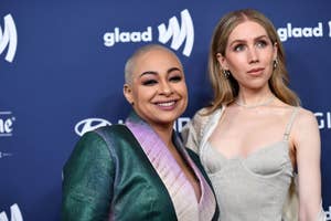 Two women posing, one in a green jacket and the other in a silver dress, at a GLAAD event
