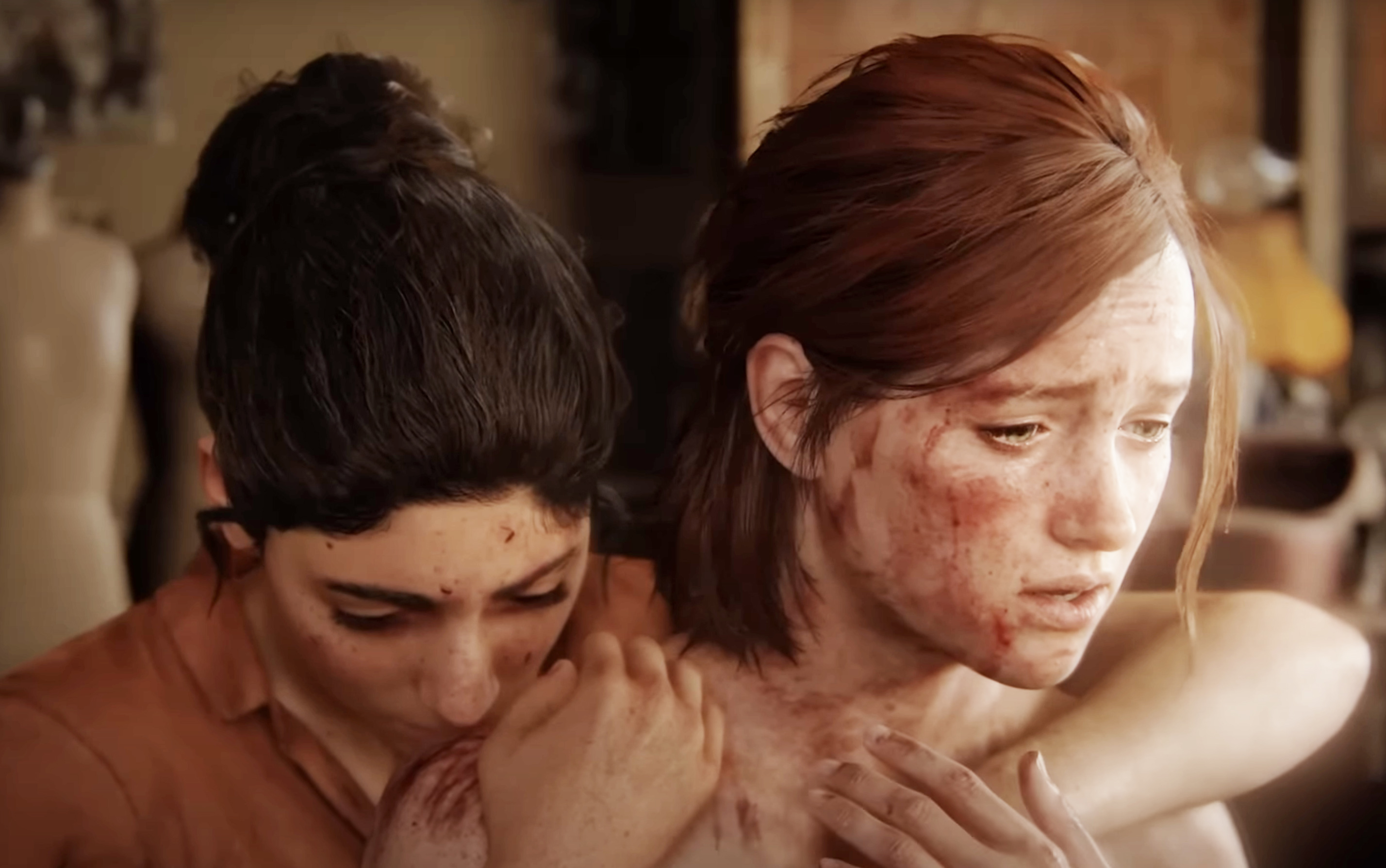 Two characters, Ellie and Dina from the video game &quot;The Last of Us,&quot; appear distressed, embracing for comfort