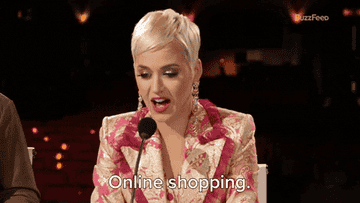 Katy Perry in a patterned suit speaks into a microphone, text &quot;Online shopping&quot; appears