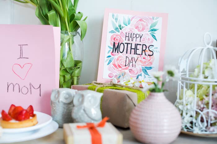 Handmade &quot;I Love Mom&quot; card, Mother&#x27;s Day card, gifts, and flowers on table, celebrating Mother&#x27;s Day