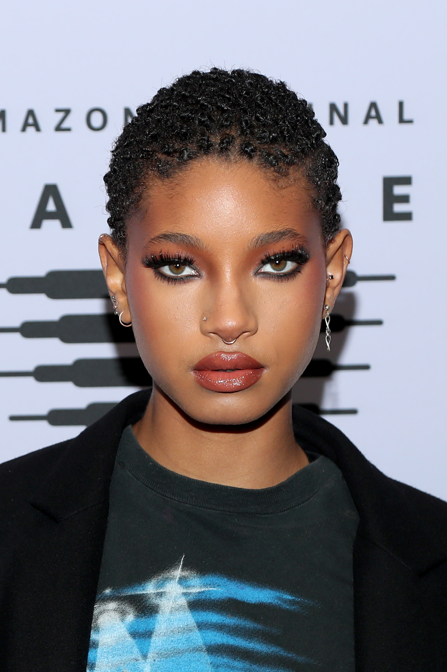 Willow Smith wearing a black blazer over a graphic tee at an event