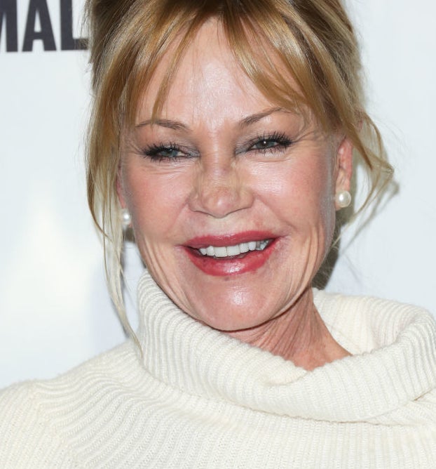 Melanie Griffith smiling at an event in  turtleneck