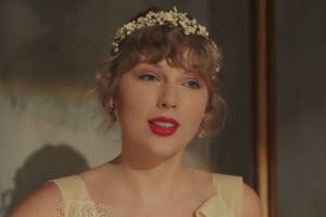 Taylor Swift wearing a vintage style dress with a floral headband in the Willow music video