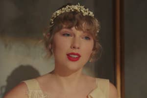 Taylor Swift wearing a vintage style dress with a floral headband in the Willow music video