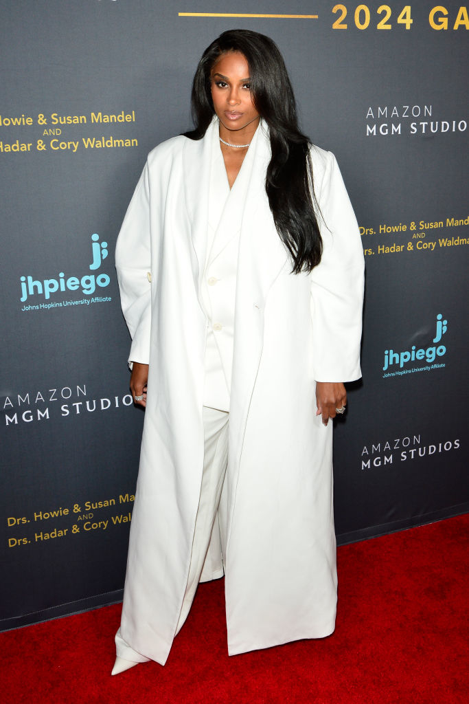 Ciara wearing an elegant white suit with a long coat at an event
