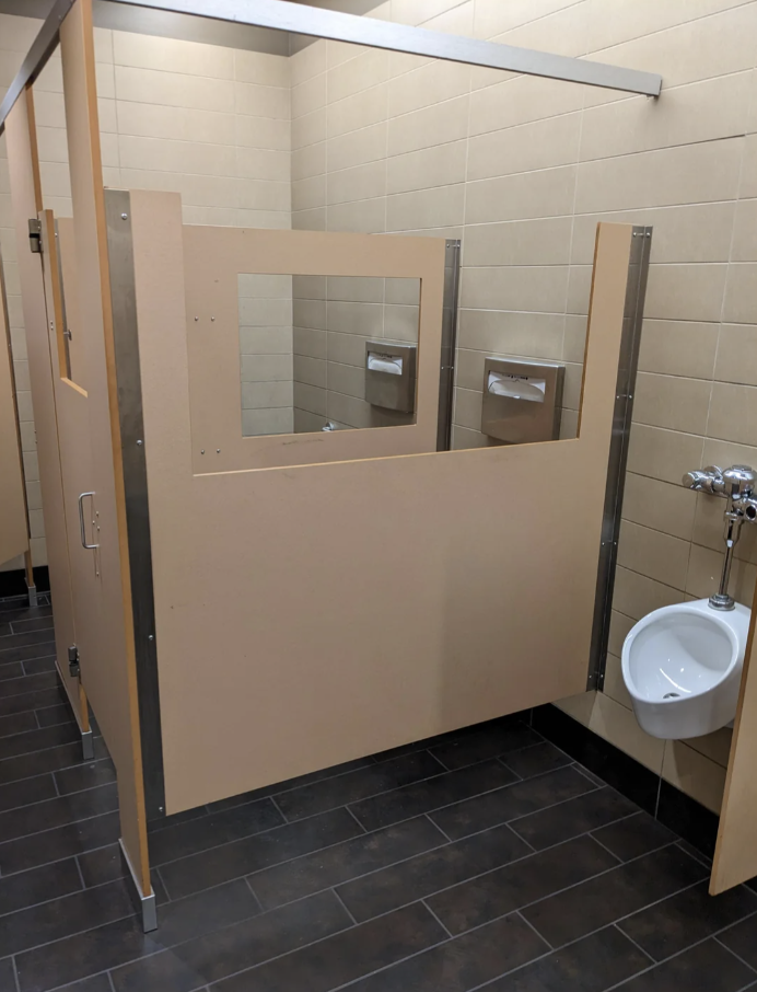 Public restroom with windows cut into each stall door