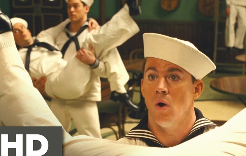 Channing Tatum as a sailor, dancing with peers in a lively musical number from a film