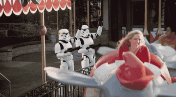 Stormtroopers waving to Darth Vader on the Dumbo ride at Disney