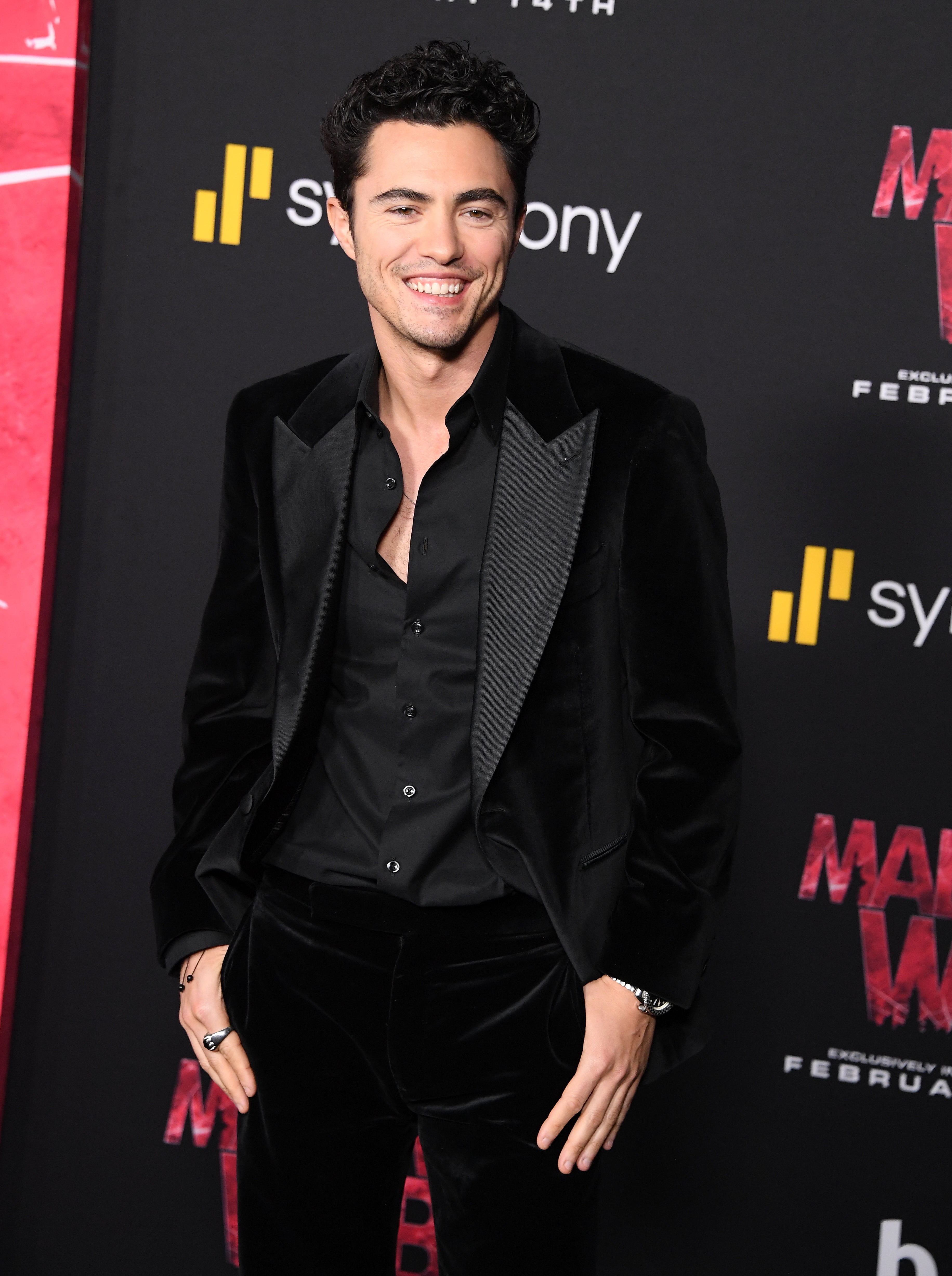 Darren Barnet in black velvet suit smiling on red carpet