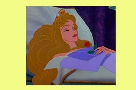 Princess Aurora from Sleeping Beauty lies asleep with a rose on her chest