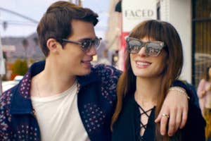 Nicholas Galitzine and Anne Hathaway walking down the street in The Idea of You