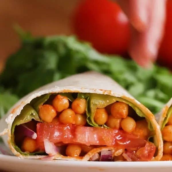 Chickpea wrap with veggies on a cutting board