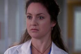 TV character in medical attire with a stethoscope, concerned expression