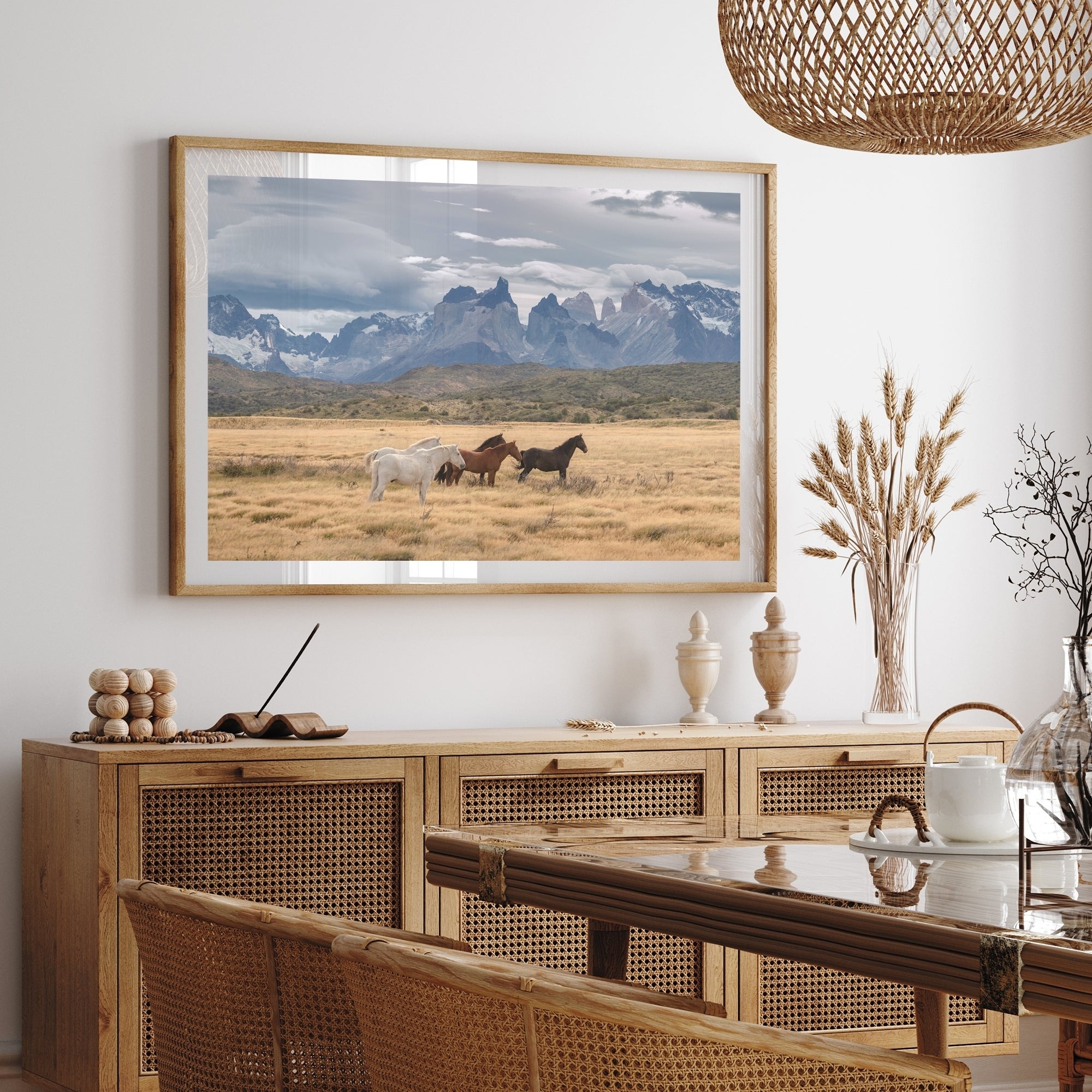 A framed picture of horses in a field hangs on a dining room wall, complementing the modern rustic decor