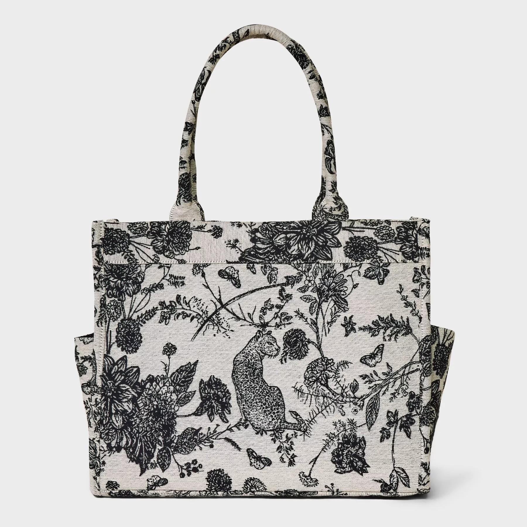 Black and beige floral print tote bag with dual handles