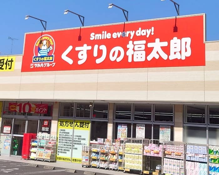 看板に「Smile every day! くすりの福太郎」とあり、店頭に商品が並ぶ日本の薬局です。